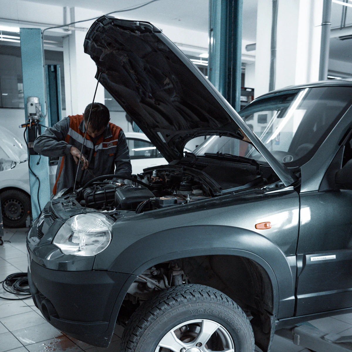 Mechanic performing a used car inspection before purchase